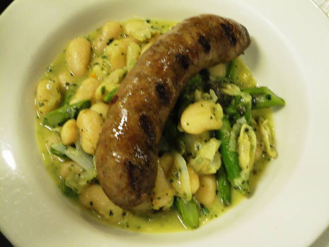 House made lamb-pork sausage, grilled, on white beans simmered with asparagus, spring onions, leeks and a mint pistou butter.