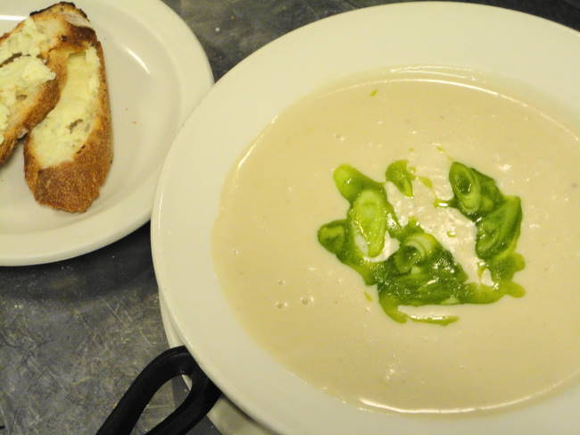 Creamy sweet garlic soup with marinated scallions and bleu cheese croutons.