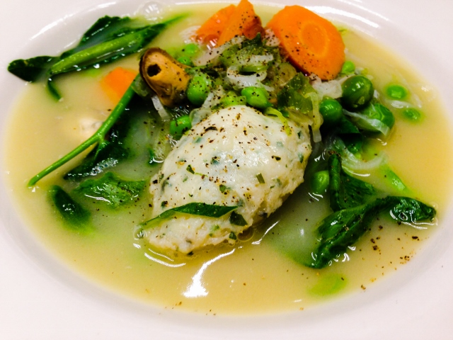 Spring fish soup with rich halibut broth, mussels, green garlic, peas, carrots and bay scallop-sole dumpling.
