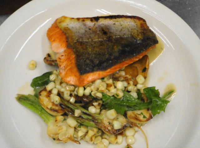 Local troll caught salmon filet served on a saute of sweet corn, chanterelles, turnips, turnip greens and finished with persillade butter.