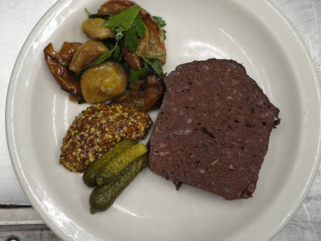 Pork blood terrine served with chestnuts and Asian pears caramelized with parsley, cornichons and grain mustard