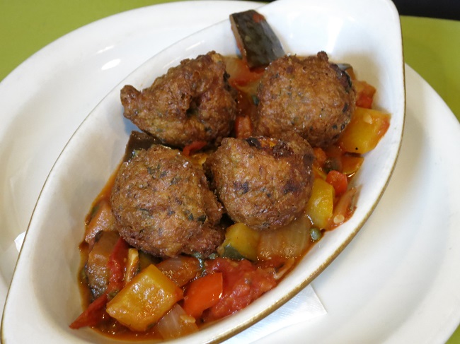 Goat cheese-thyme beignets served on summer ratatouille