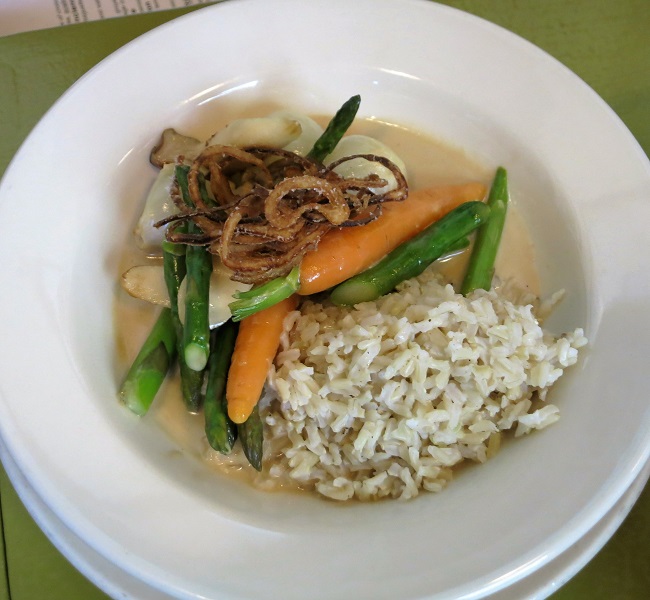 Spring vegetable blanquette of asparagus, carrots, pearl onions and king oyster mushrooms in a white wine chevre sauce, with crispy shallots and brown rice.