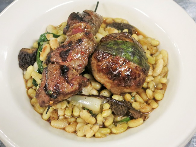 Grilled lamb brochette and lamb-pork crépinette on flageolet beans sauteed with spring morels, green garlic, spring onions and ramps, with a rich lamb-red vermouth jus.