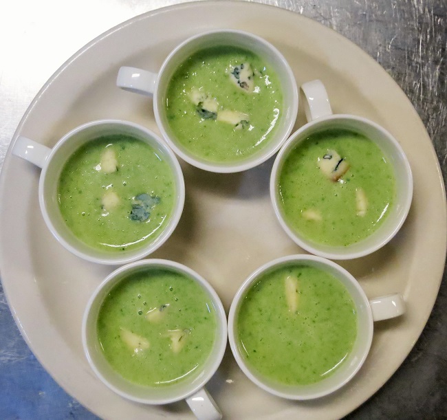 Potato-leek-asparagus soup garnished with Fourme d'Ambert