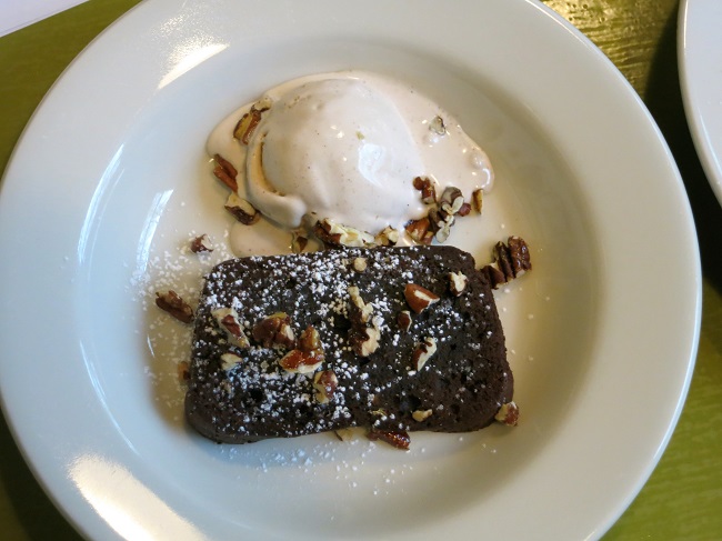 Traditional gateau au chocolat, served warm with pecan-brandy ice cream and candied pecans