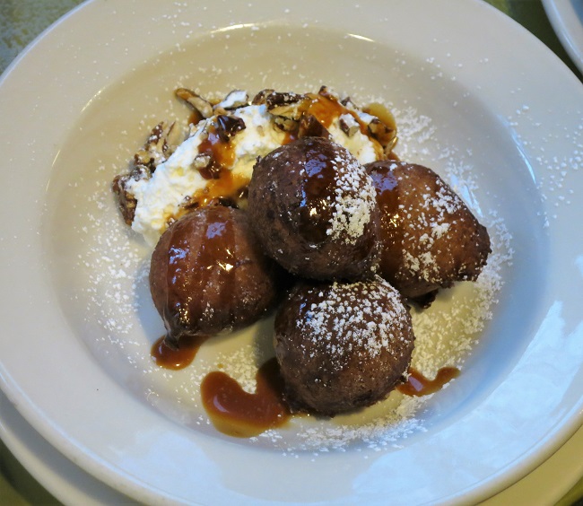 Crispy banana fritters with whipped cream, candied pecans and rum caramel