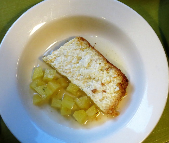 Caramelized rice cake served with vanilla-poached pineapple and fresh cream.