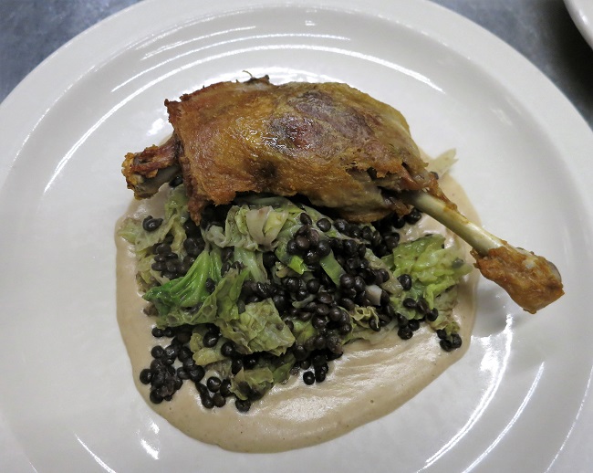 Crispy duck leg confit served on black lentils sauteed with Savoy cabbage and house white wine vinegar and chestnut puree