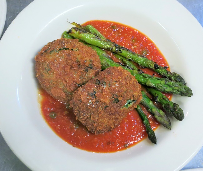 Goat cheese-spinach croquettes served with sauce tomate with capers and candied lemon and grilled asparagus.