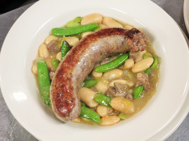 Lamb-pork sausage served on white beans simmered with lamb heart, favas, snap peas, leeks and mint.