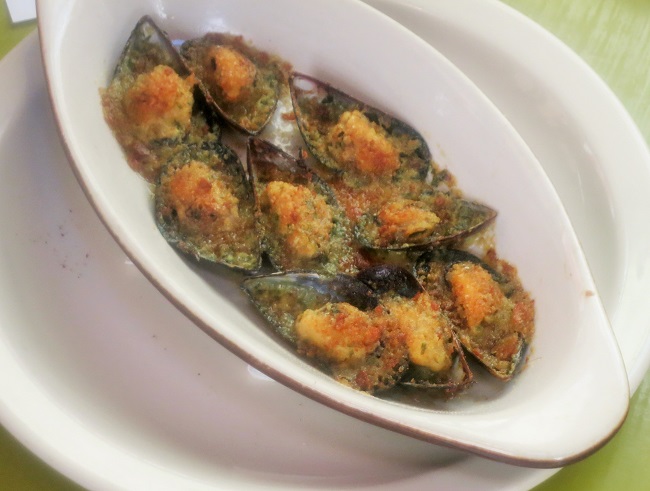 Penn Cove mussels broiled with garlic-parsley-cognac butter and bread crumbs