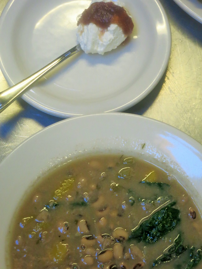 White bean soup with Delicata squash and kale, garnished with creme fraiche and apple butter