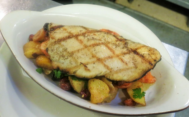 Heirloom carrots and Yukon potatoes roasted with black currants, parsley, hazelnuts and sherry vinegar, topped with a grilled trout filet