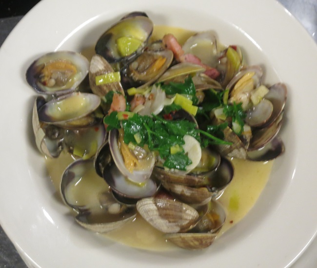 Penn Cove clams sauteed with house-made pancetta, leeks, garlic, parsley and sweet garlic-white wine fumet