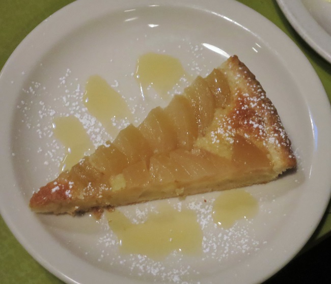 White wine poached pear and almond cream tart, served with spiced honey syrup
