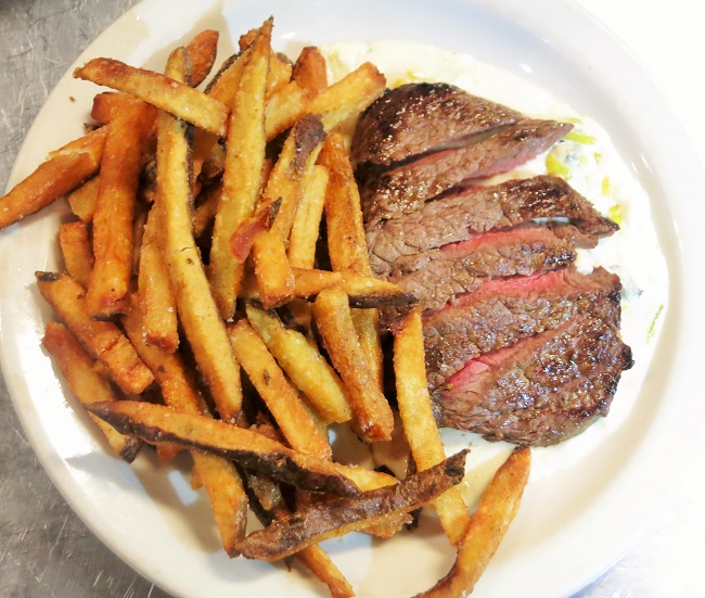 Petit sirloin steak frites served with a creamy leek and blue cheese sauce