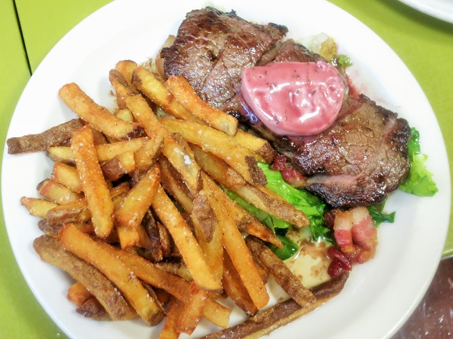 Grass fed petit sirloin steak frites with bacon sauteed escarole and plums, port wine-thyme butter
