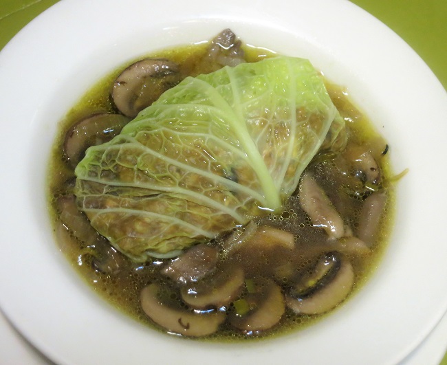 Savoy cabbage leaf stuffed with whole grain barley, cabbage, onion, winter squash and dried figs, served on a ragout of leeks and Fall mushrooms