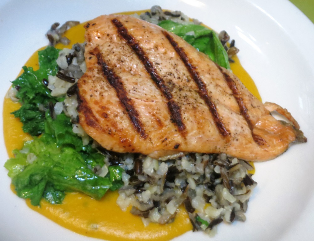 Arctic Char filet grilled and served on wild and brown rice pilaf, mustard greens and kabocha squash-brown butter puree