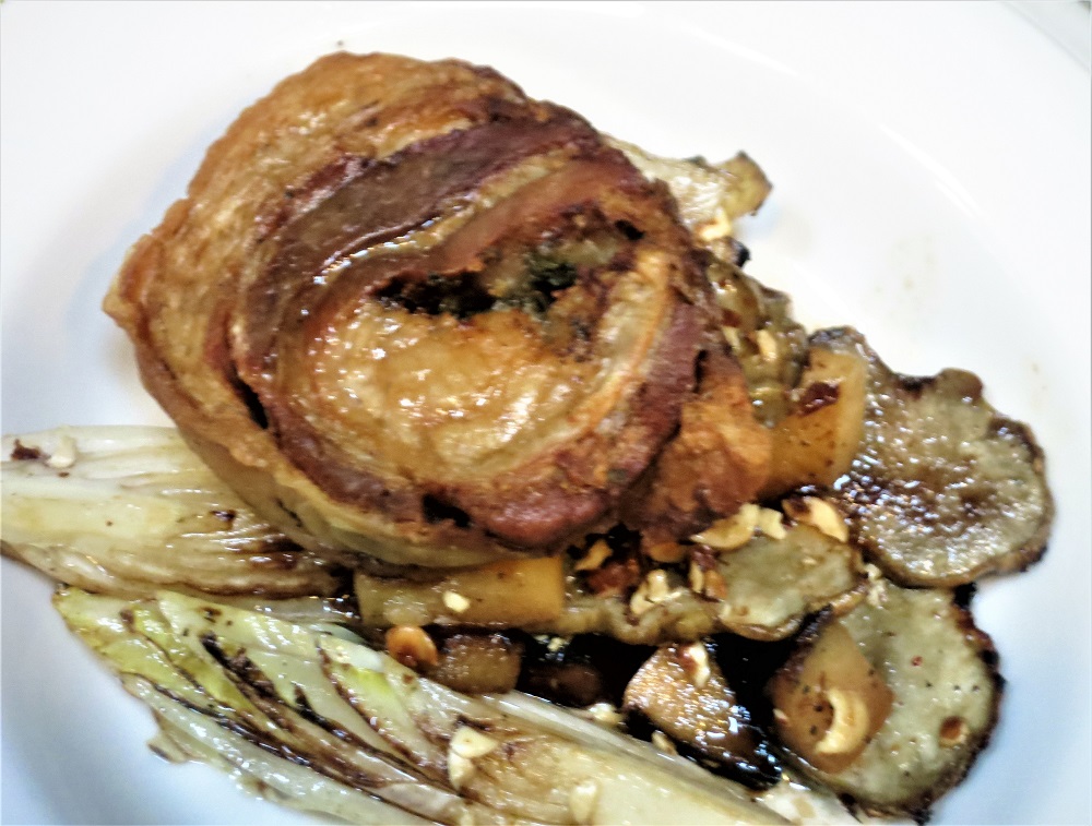 Crispy pork belly-sage roulade served with roasted Belgian endive, sunchokes, apples and aged sherry vinegar