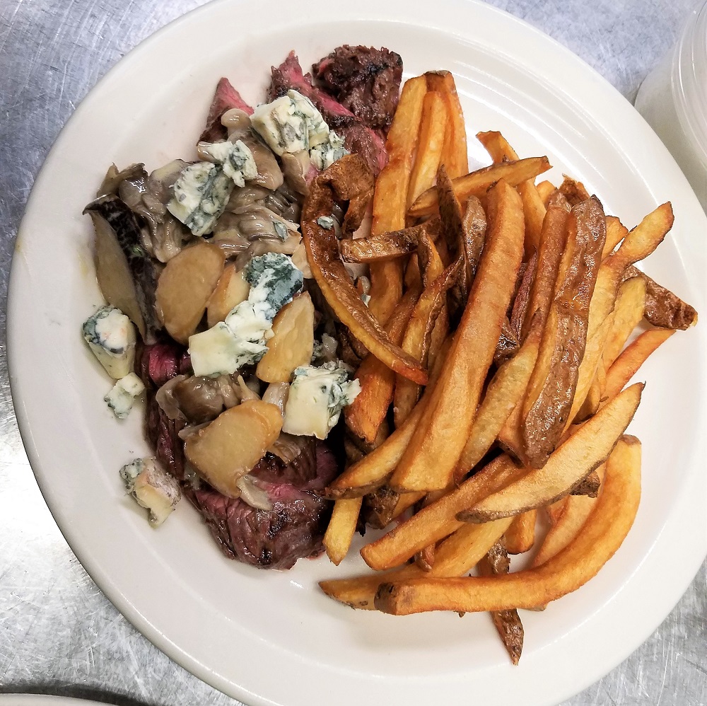 Grilled grass-fed beef skirt steak, Oyster mushroom and  Hen of the woods cream sauce, cow’s milk bleu cheese,  and  pommes frites 